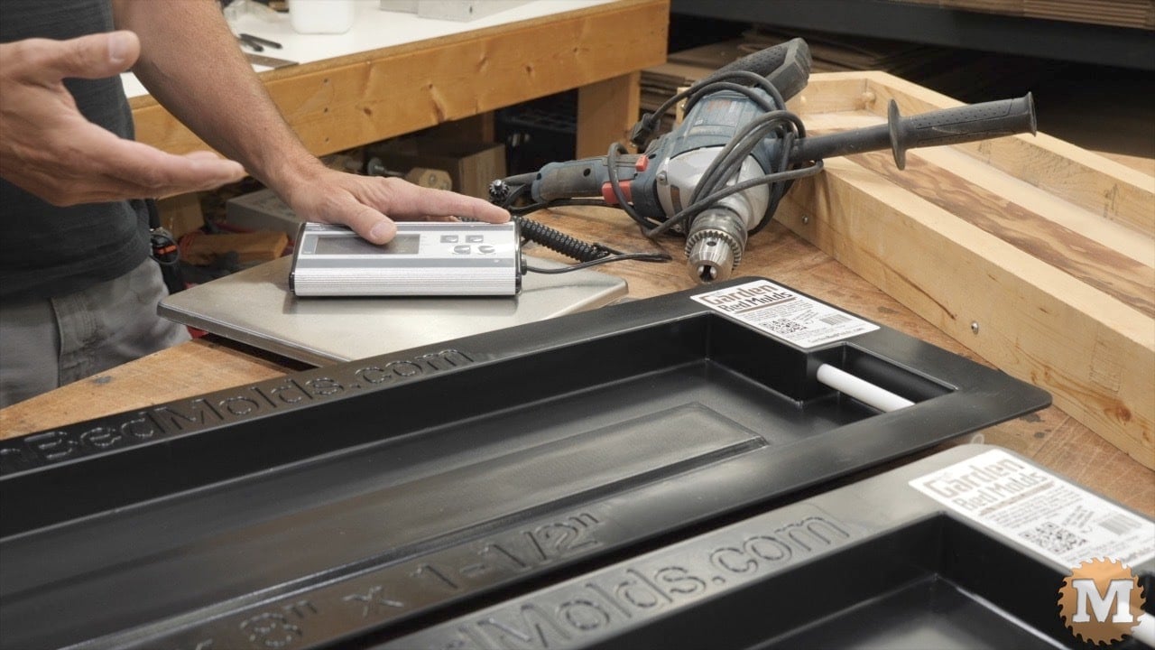 a drill, digital scale, and plastic concrete mold