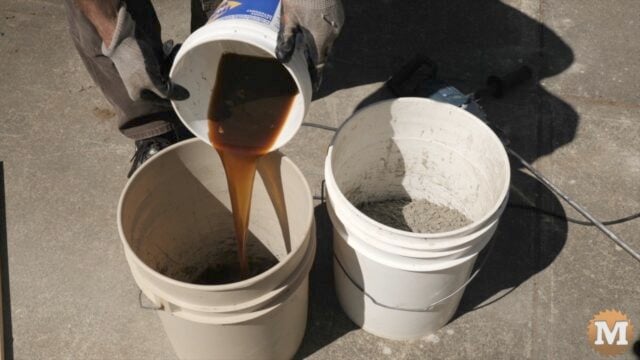 adding water and plasticizer to a 5 gallon pail