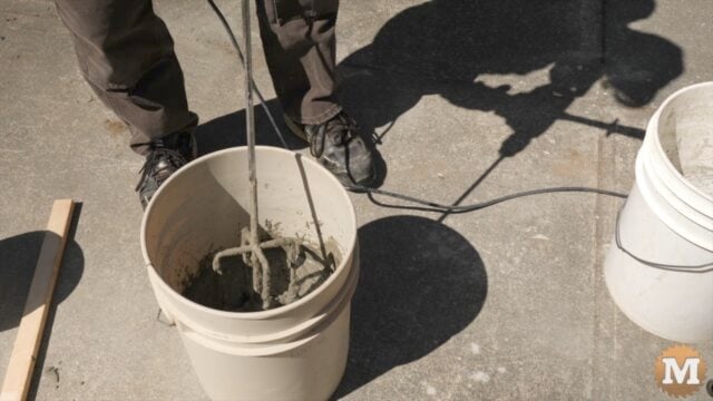 mixing concrete in a pail
