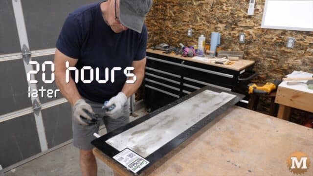 a man inserting a nail into a hole in a pipe