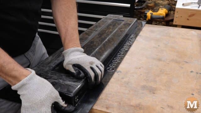 Hands on the back of a plastic concrete mold
