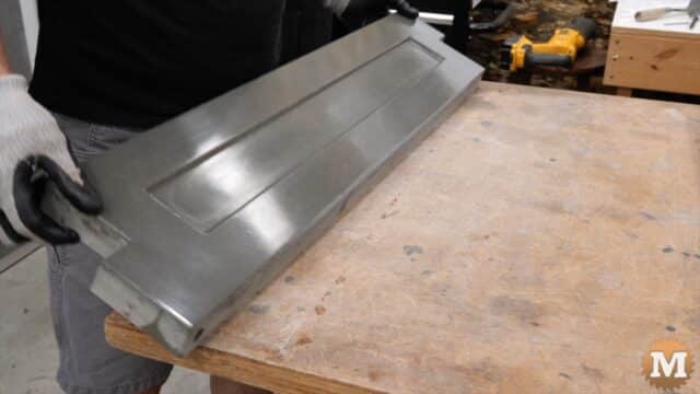 a thin concrete casting being held by a man