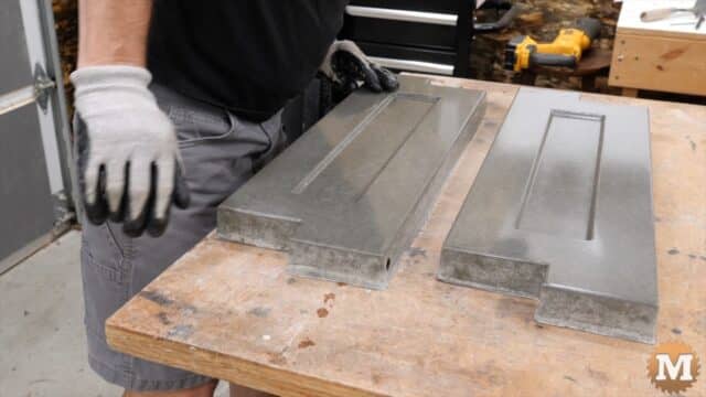 two concrete castings on a workbench