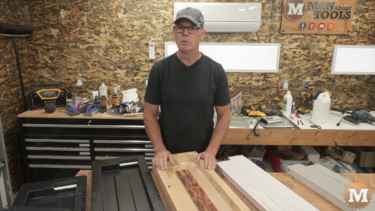 man in workshop in front of concrete molds