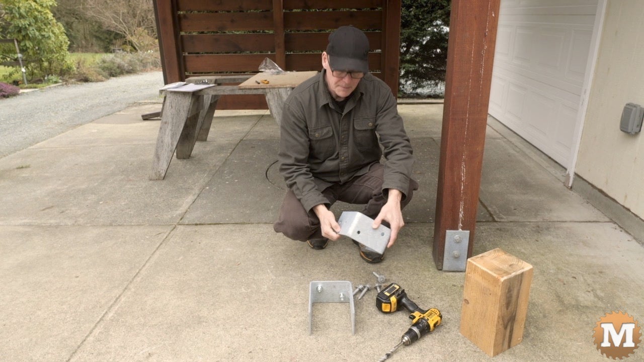 A man holding a galvanized heavy duty post saddle