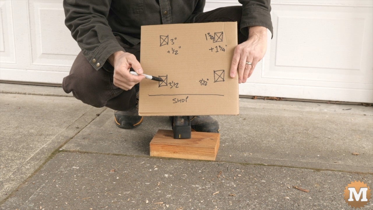 A man holding a drawing on cardboard