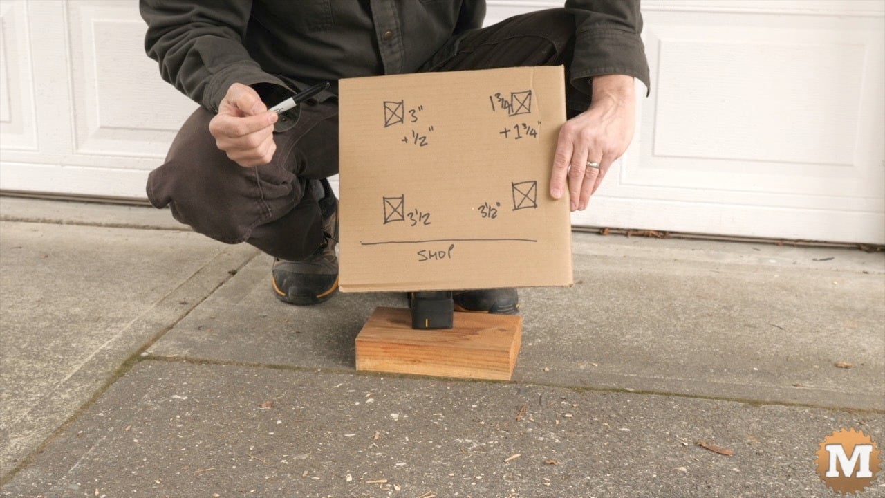 A man holding a drawing on cardboard