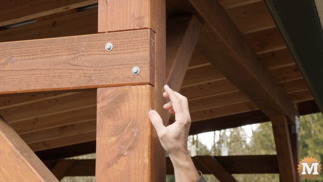 A hand pointing to a dado cut