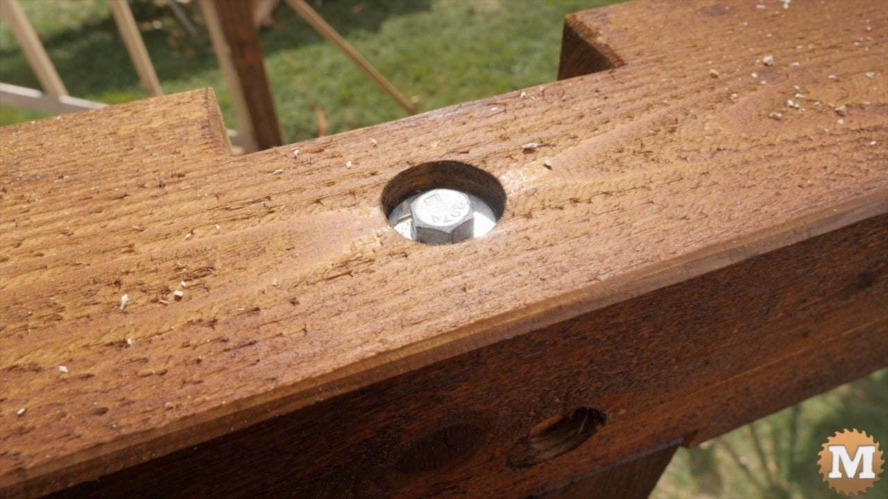 The recessed head of a lab bolt in a beam