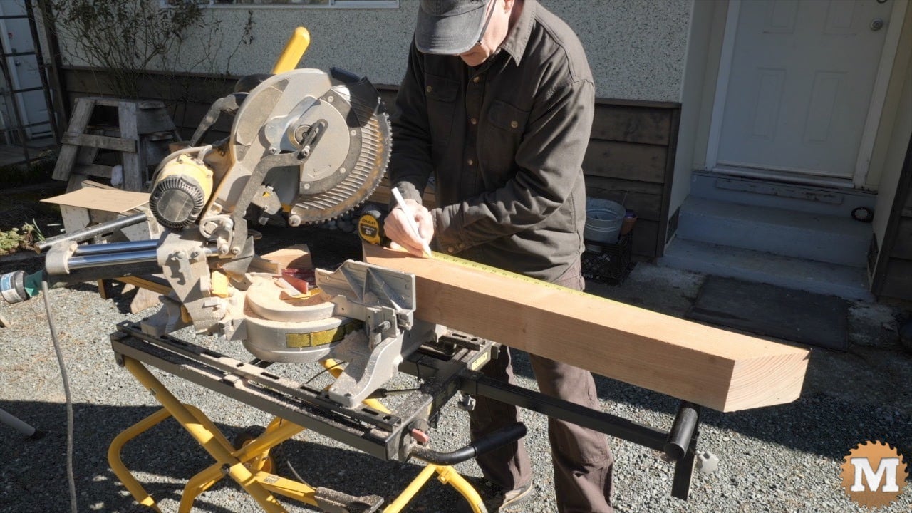 A man marking pencil lines on wood