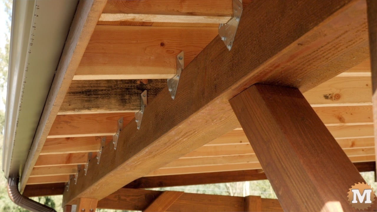 a wooden structure with metal brackets