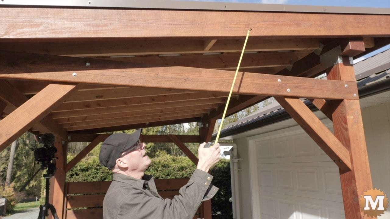 a man measuring a roof