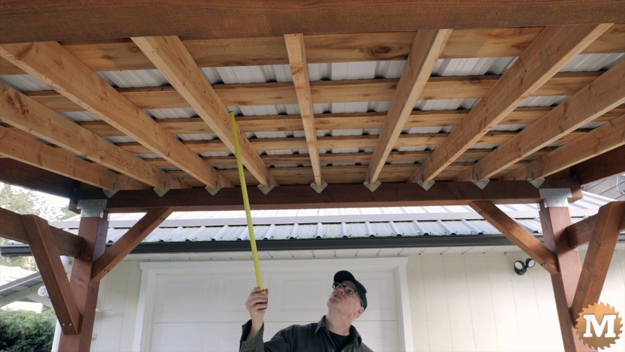 a man holding a yellow tape measure