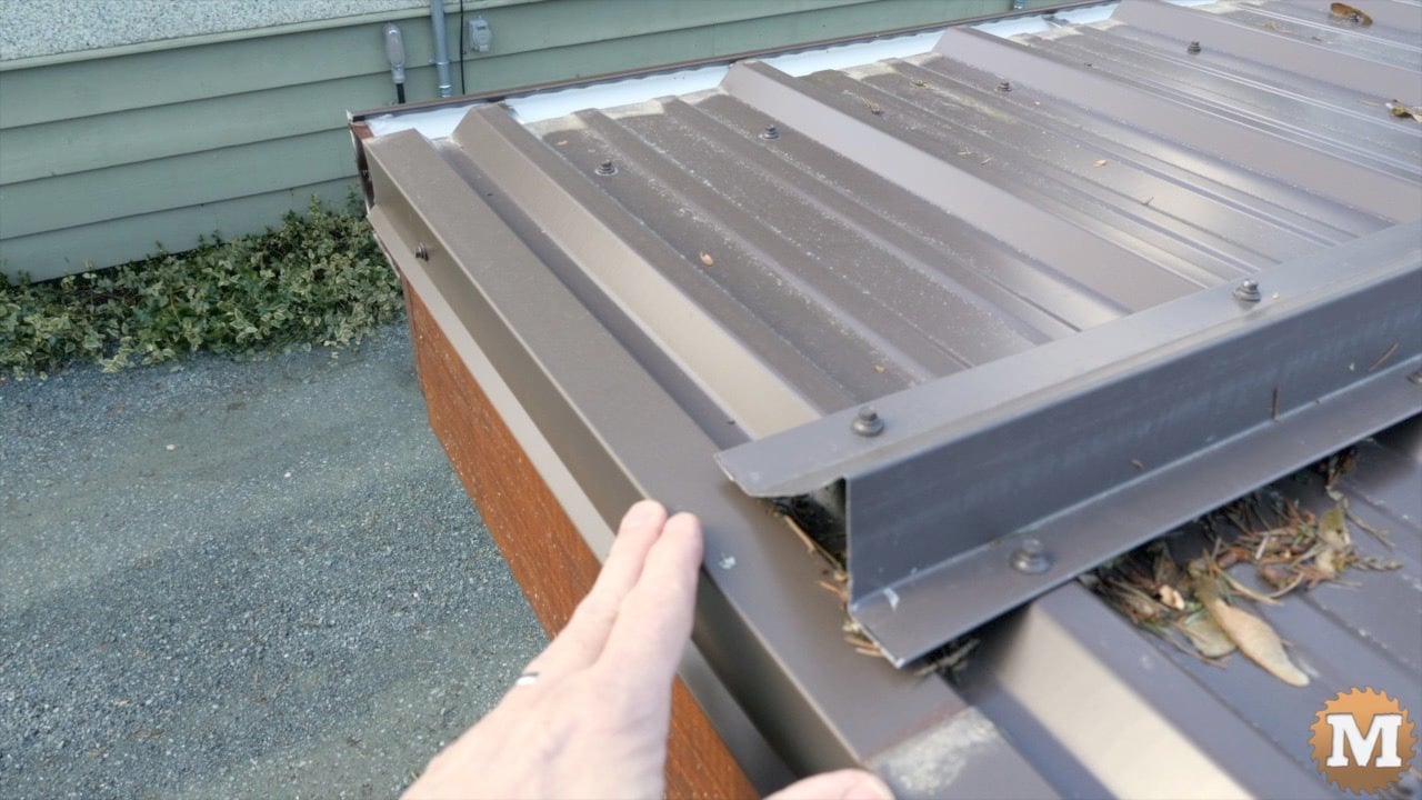 a person's hand on a roof