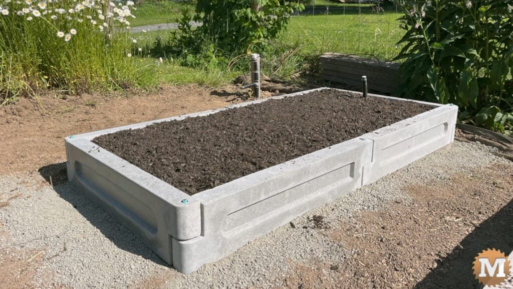 completed round end concrete garden bed with topsoil
