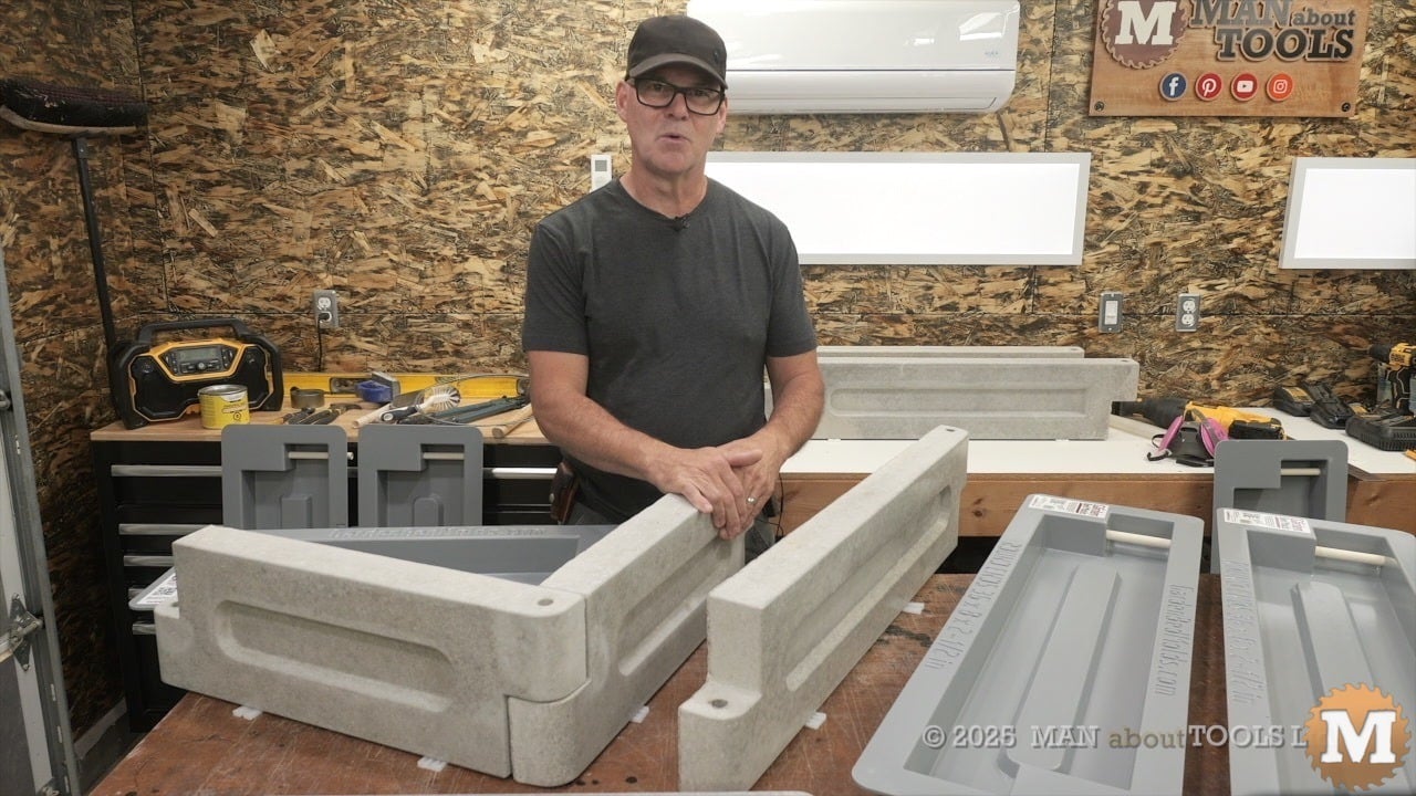 man speaking to camera behing concrete castings on a table