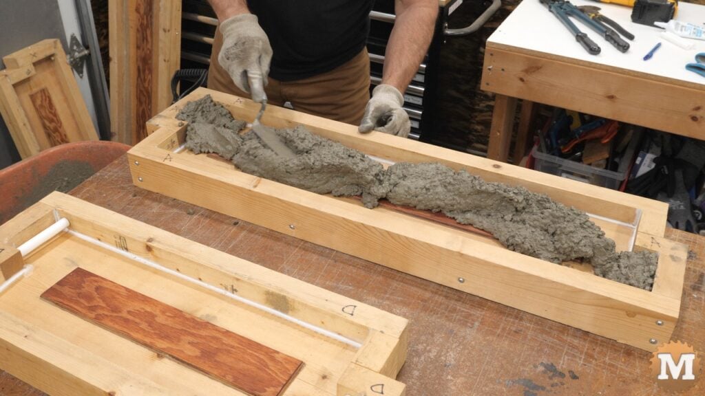 filling a wooden mold with wet concrete