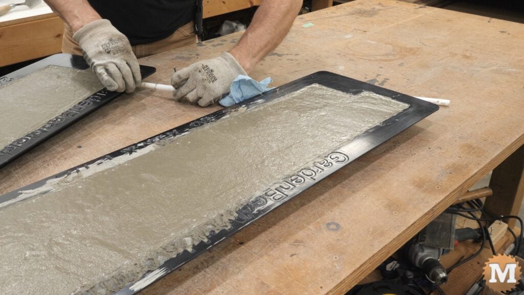 plastic pipes being extracted from a concrete casting mold