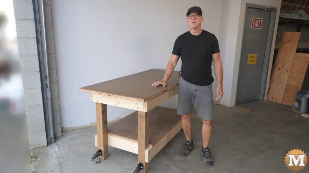 a man standing beside a diy workbench