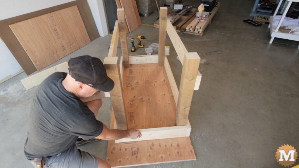 a man building a wooden workbench