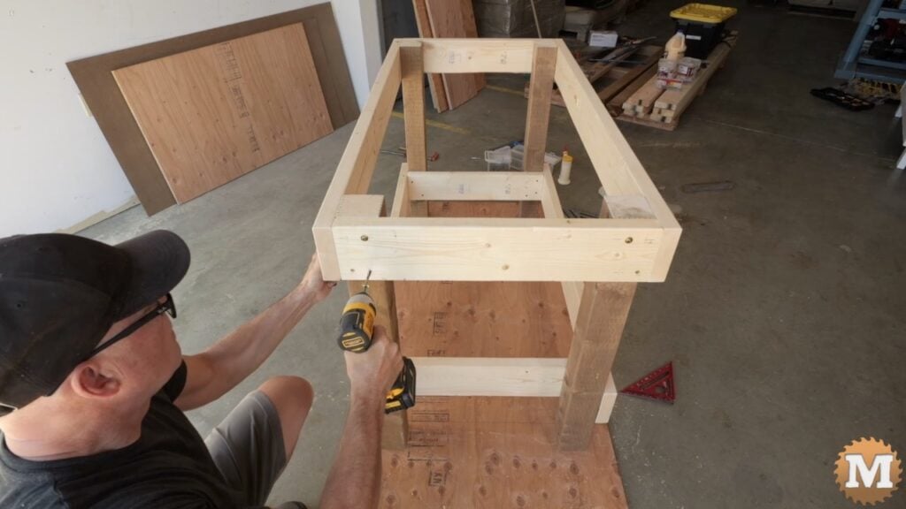 a man building a wooden workbench