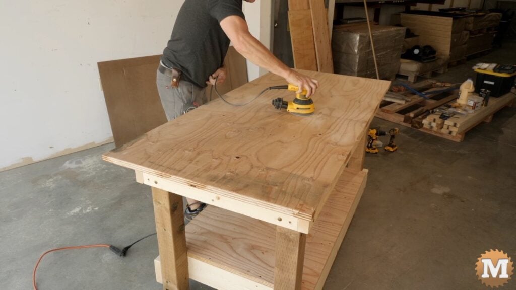 a man using an orbital sander on plywood