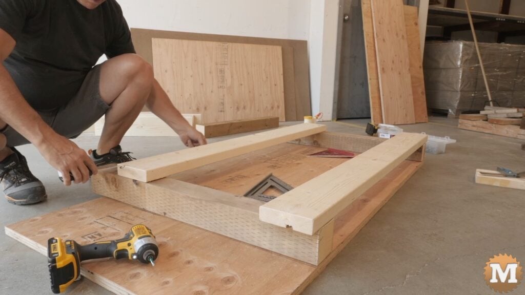 a man building a wooden workbench