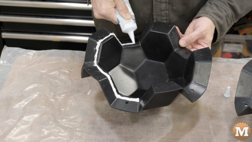 Applying a bead of latex caulk to the flange of the plastic two-part casting mold